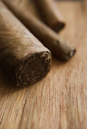 Some cigars over wooden texture, selective focusの写真素材