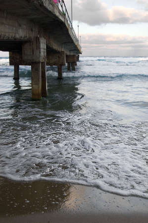 Concrete old bridge over sea and dramatic skyの写真素材