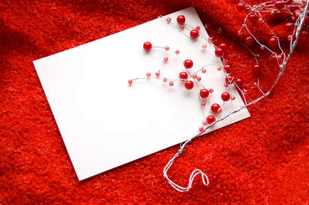 White blank note with red beads decoration on red backgroundの写真素材