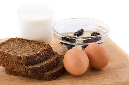 Milk, eggs, bread and cottage cheese on whiteの写真素材