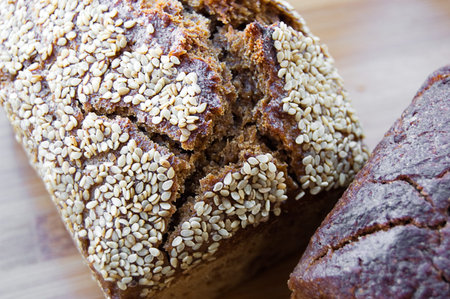 Loaf of bread with sesame on wooden boardの写真素材