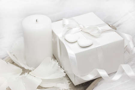 White gift box with candle and tulipの写真素材