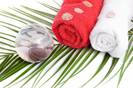 Bath towels and spa products with palm branchの写真素材