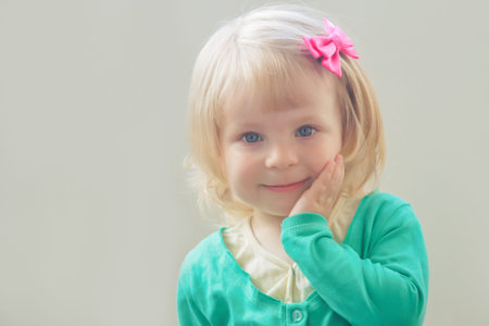 Lovely portrait of smiling baby girl with bow