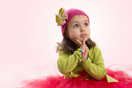Adorable girl in tutu and hat with butterfly over pinkの写真素材