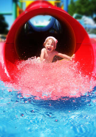 Screaming girl riding down the water slideの写真素材