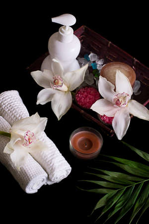 White orchids, spa treatment in wooden box isolated on blackの写真素材