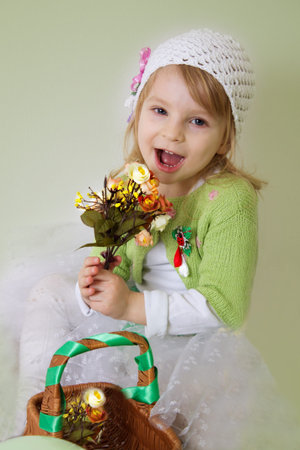 Cute girl enjoying spring flower blossom with basket