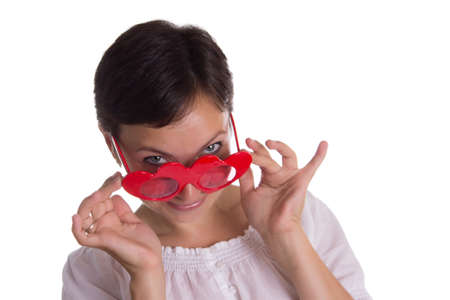Looking-up surprised woman with funny glasses heart-shaped isolated on whiteの写真素材