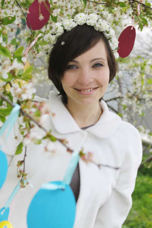Sensual woman with wreath among spring gardenの写真素材