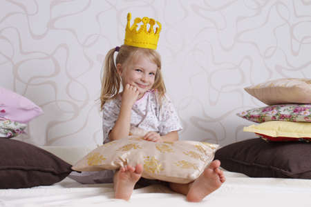 Cute girl in princess crown at pyjamas partyの写真素材