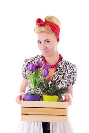 Pinup flower woman holding some pots isolated on whiteの写真素材