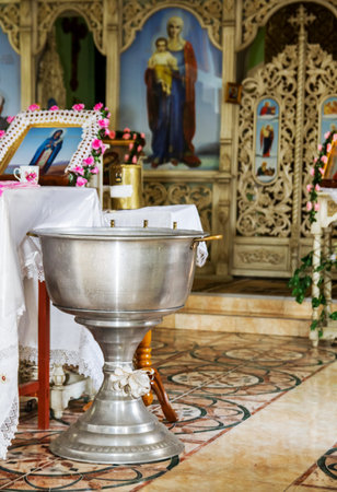 Orthodox bowl of holy water and candles for christening. Moldova