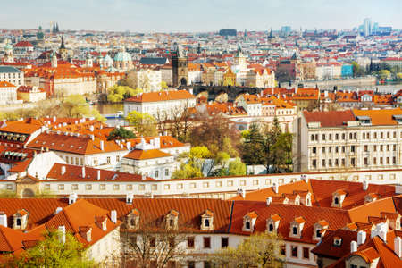 Buildings and churches with red rooftops in old city in Pragueの写真素材