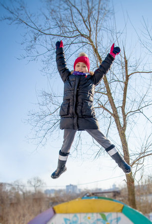 Girl jumping in winterの写真素材
