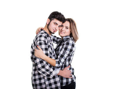 Young couple in skirts hugging isolated on whiteの写真素材