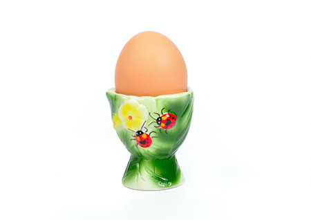 Egg on the support against the white background.