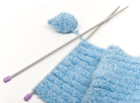 Binding and knitting needle against the white background.