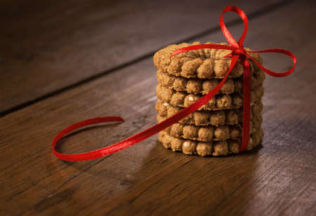 Biscuits with red ribbon on the table.の写真素材