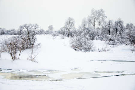 Snowy landscape on the riverの写真素材