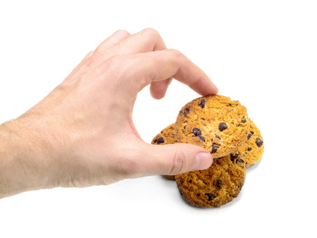 Holding cookies close-up on white background