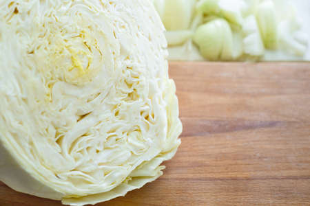 Cabbage shredded on wooden chopping boardの写真素材