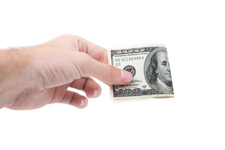 Hundred dollars in man's hand close-up isolated on white