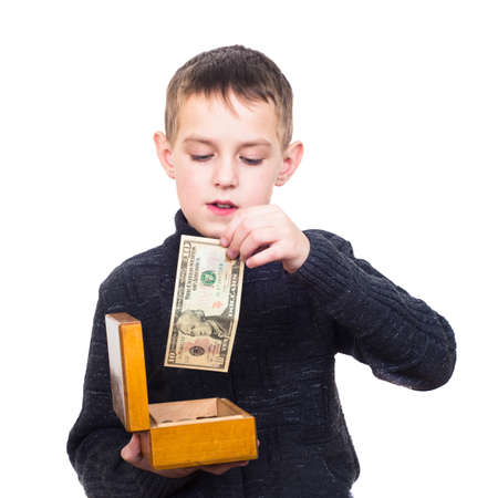 Close up portrait of boy counting money isolated on whiteの写真素材