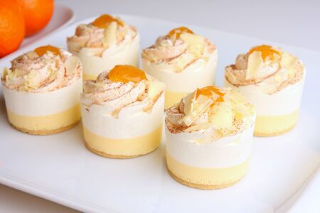 little cream cakes with vanilla, orange and white chocolate flavour の写真素材