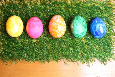 Colorful Easter eggs on artifical grassの写真素材