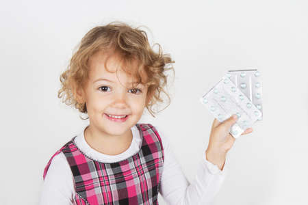 little girl with medicines in handの写真素材
