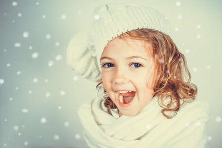 happy little girl with hat and white scarfの写真素材