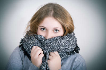 Teenager is shaking from the cold winterの写真素材