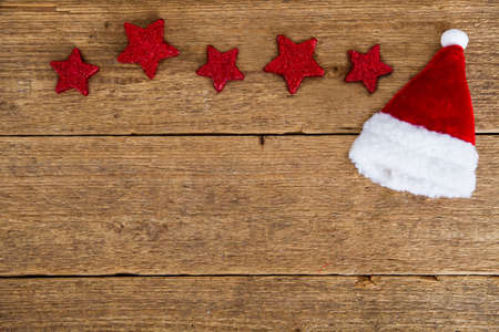 red stars and Santa's hat on woodの写真素材