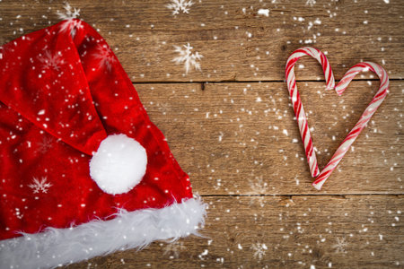 santa's hat and candy cane on wooden backgroundの写真素材