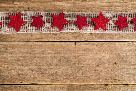 wooden background with red starsの写真素材