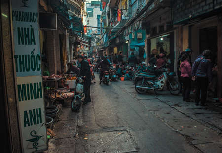 Hanoi, Vietnam - January 23, 2017 - Local Vietnamese people buying groceries, in a side street, within the old quarter.のeditorial素材