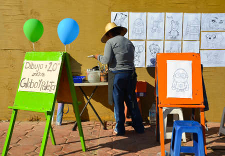 Mexico-August 2014: Woman Setting Up Painting For Kidsのeditorial素材