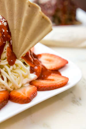 sliced ??strawberries with ice cream on waffleの写真素材