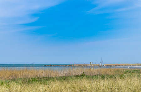 Baltic Panorama with a turquoise sea and sailing boats on the horizon on a sunny summer dayの写真素材