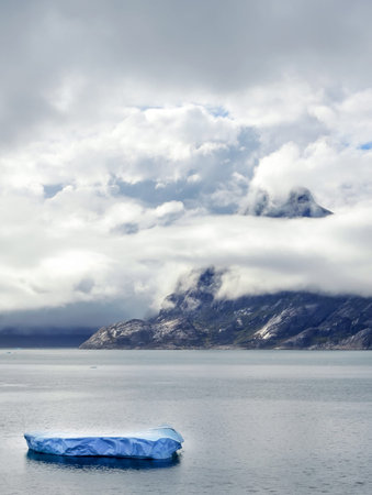 Prince Christian Sound in Greenland, black mood with overcast mountains