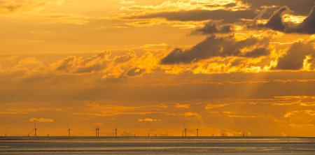 Panorama of an offshore wind farm in the sundownの写真素材