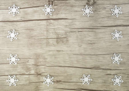 Bright wooden board with decorative white snowcrystals borderedの写真素材