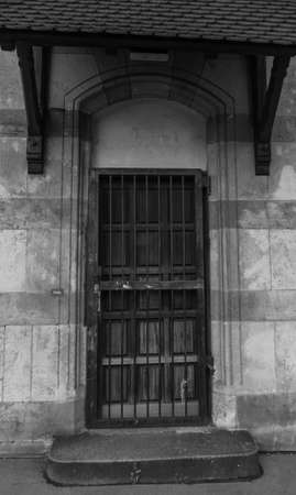 Latticed old wooden door in black and whiteの写真素材