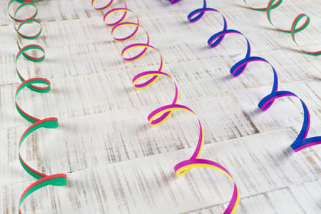 Colorful streamers on wooden backgroundの写真素材