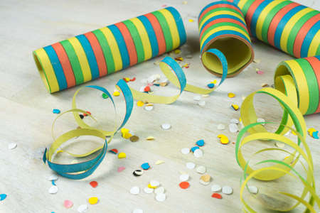 Rolls of streamers and confetti on wooden backgroundの写真素材