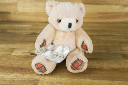 Teddy with a blister of tabletsの写真素材