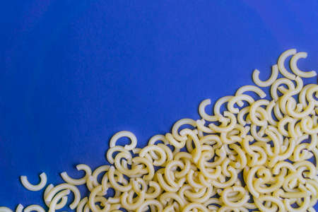 Raw noodles on blue background, copy spaceの写真素材