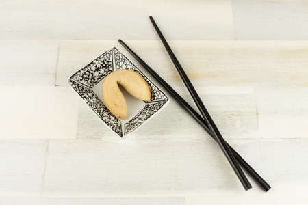 Fortune cookie with chopsticksの写真素材