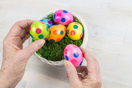 Colorful easter eggs in a basketの写真素材
